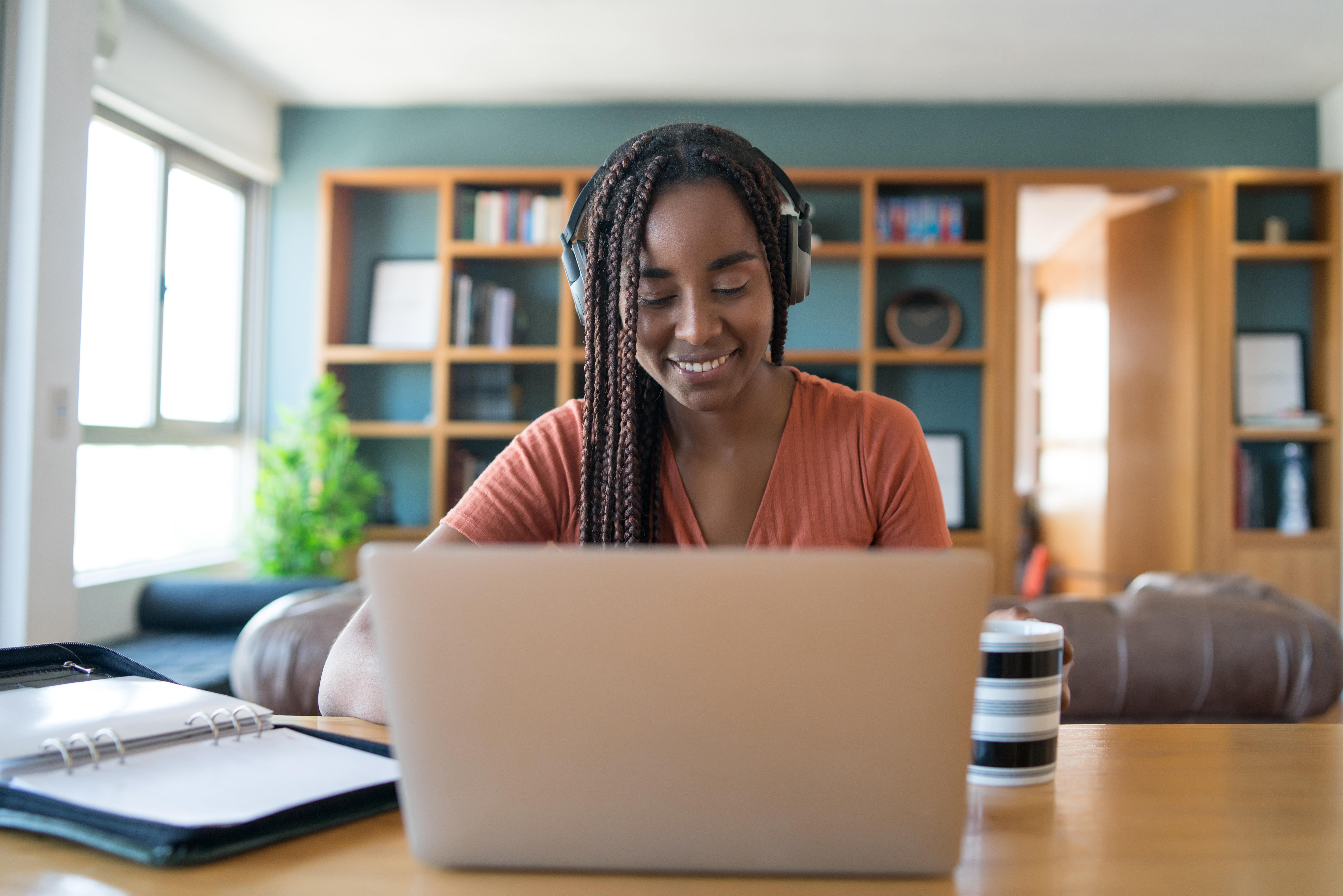 portrait-woman-video-call-with-laptop-headphone-min